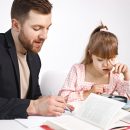 Girl with Down syndrome studying with her teacher at home