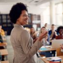 Happy,African,American,Professor,Receives,Applause,From,Her,Students,While